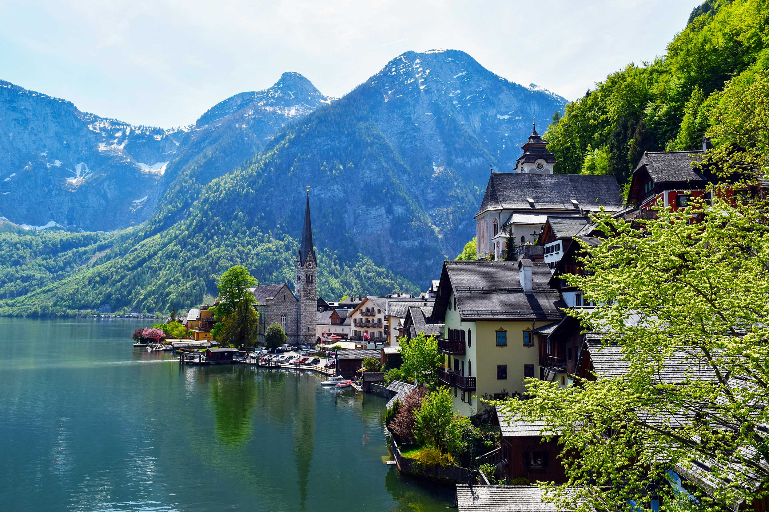 a town on the water with Hallstatt in the background